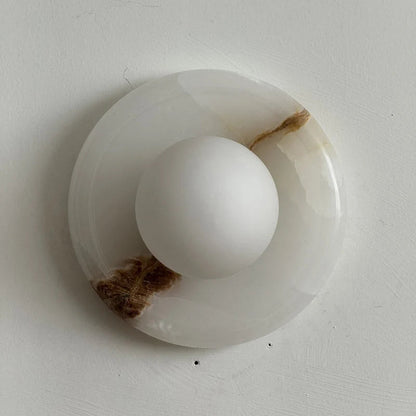 Wall light featuring a natural onyx backplate and a stylish glass globe, designed for hardwired indoor installation, perfect for enhancing home decor. 35