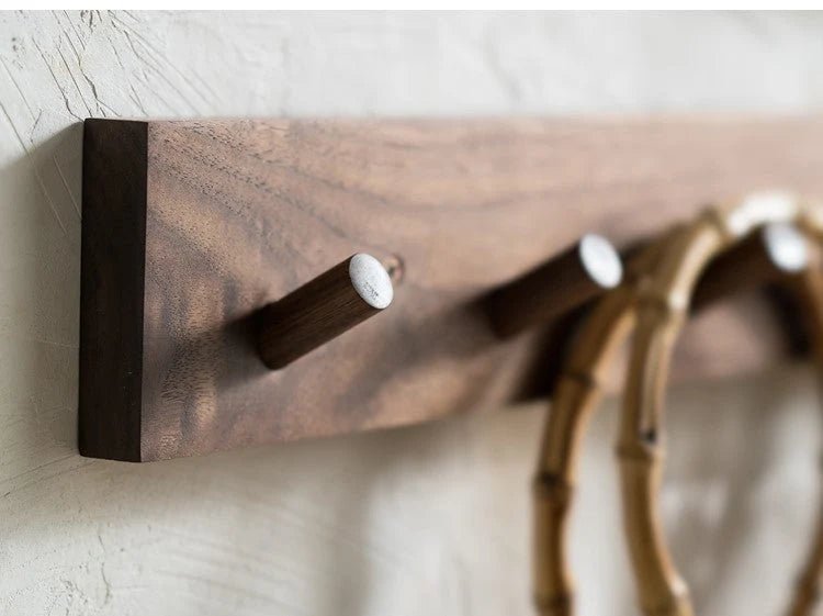 Wall mounted coat rack featuring round pegs, crafted from minimalist solid wood in walnut or beech, perfect for modern entryway decor. 0