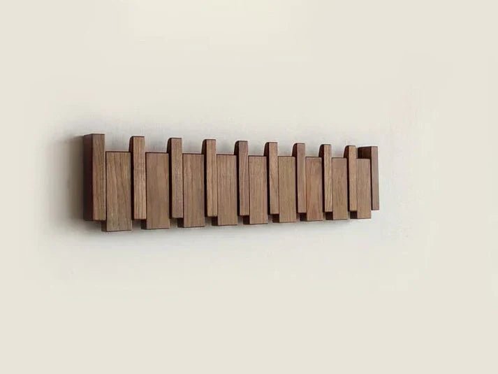 Wall-mounted wooden coat rack featuring foldable hooks in a stylish piano key design, crafted from solid timber for durability and elegance. 6