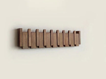 Wall-mounted wooden coat rack featuring foldable hooks in a stylish piano key design, crafted from solid timber for durability and elegance. 6