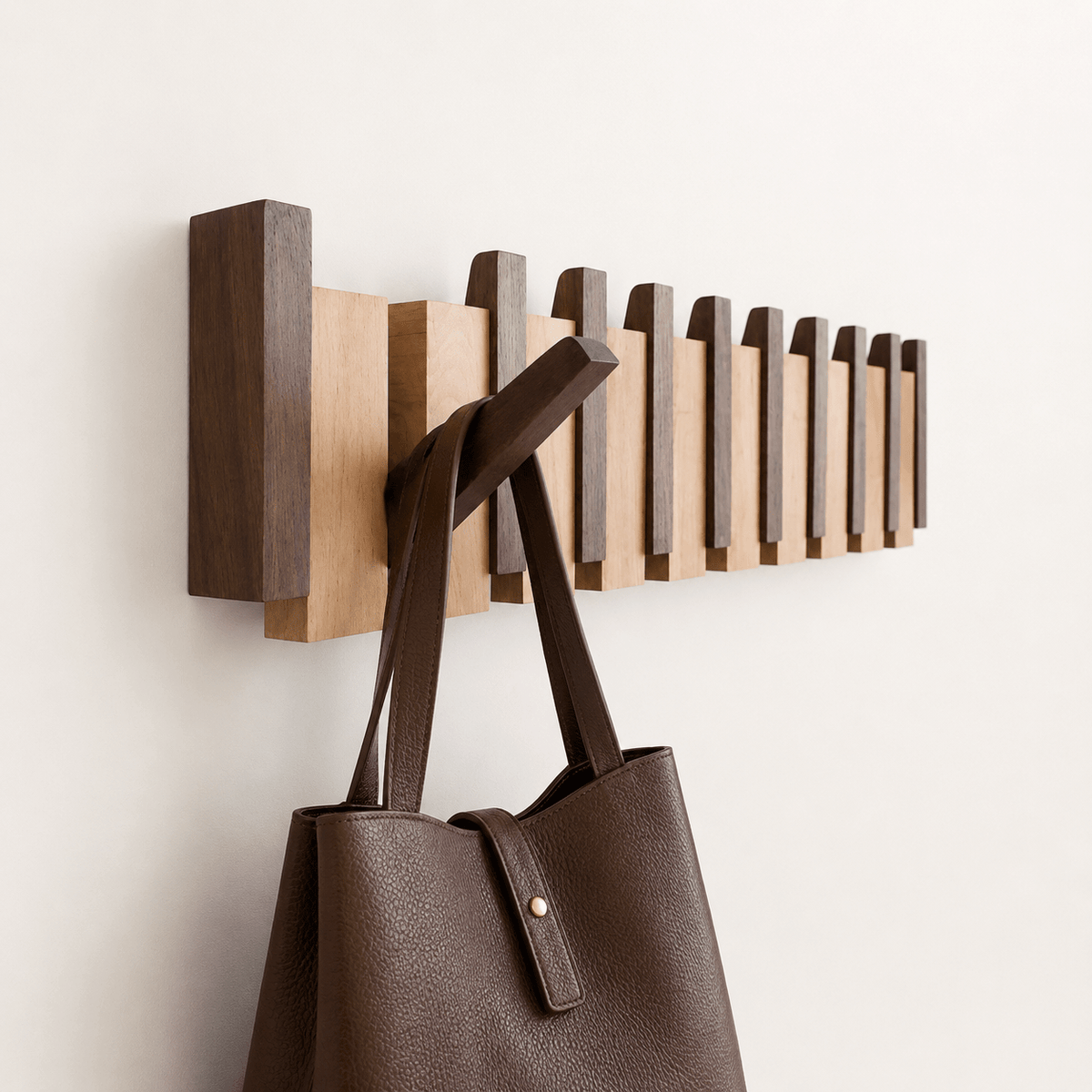 Wall-mounted wooden coat rack featuring foldable hooks in a stylish piano key design, crafted from solid timber for durability and elegance. 0