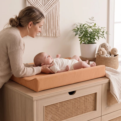 Waterproof baby changing pad with cushioned contoured support, featuring a neutral design ideal for modern nurseries. 4