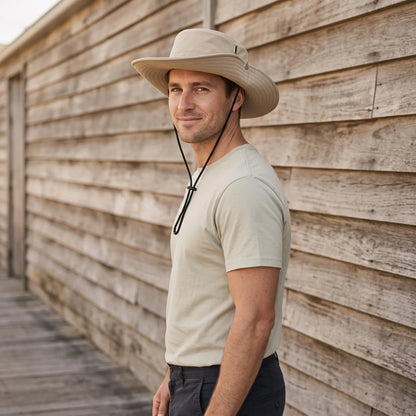 Wide brim bucket hat with adjustable chin strap for casual outdoor sun protection, made of polyester with a ventilated design. 0