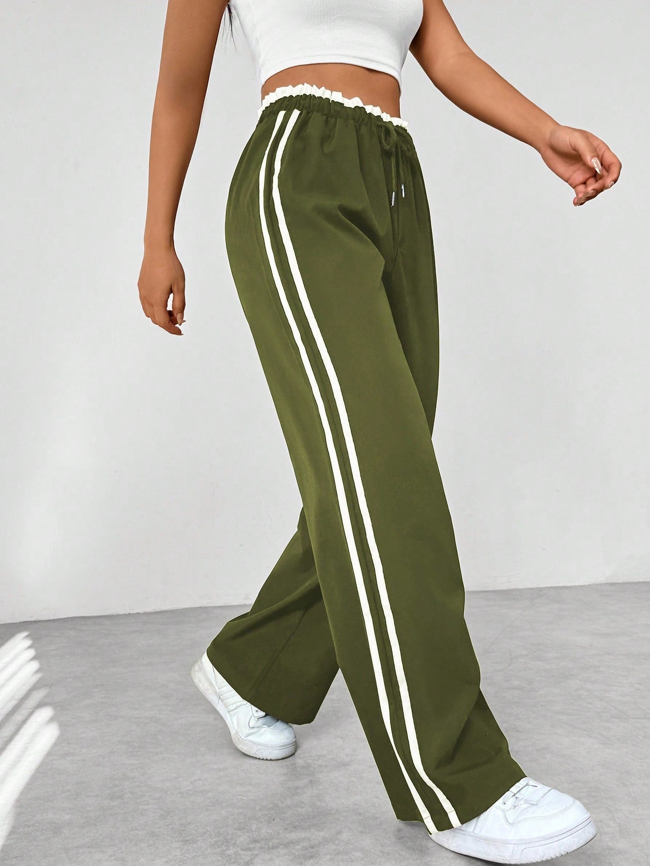 Wide leg trousers for women featuring sporty side stripes, crafted from airy fabric with an elastic waistband for comfort and style. 7