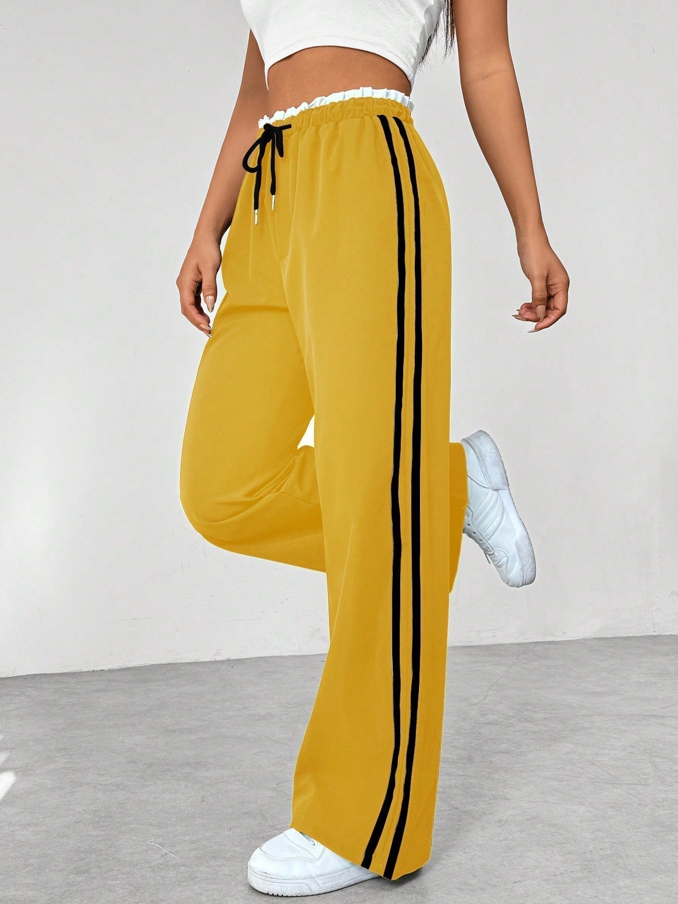 Wide leg trousers for women featuring sporty side stripes, crafted from airy fabric with an elastic waistband for comfort and style. 5