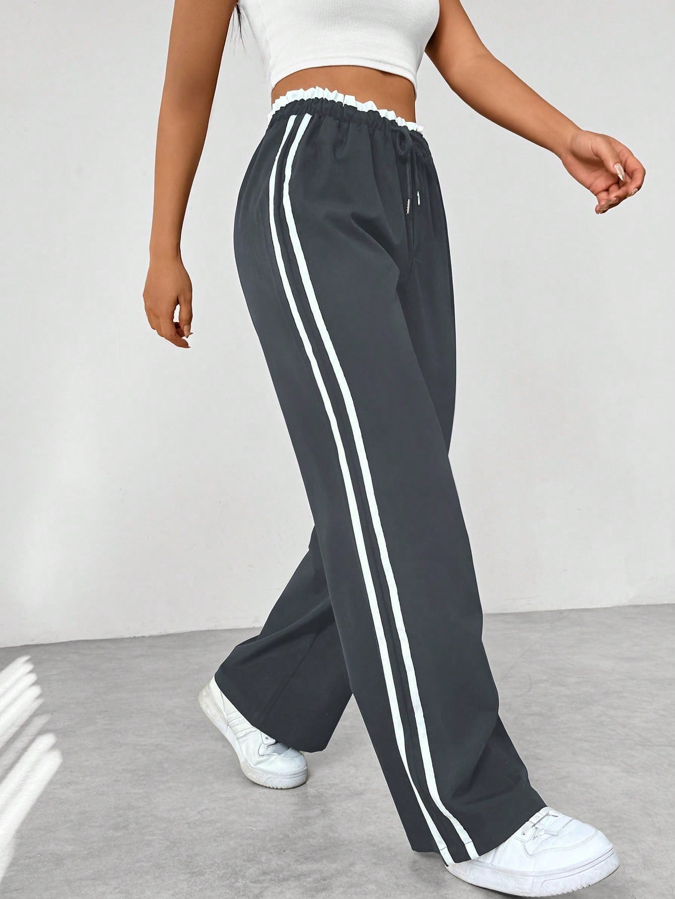 Wide leg trousers for women featuring sporty side stripes, crafted from airy fabric with an elastic waistband for comfort and style. 3