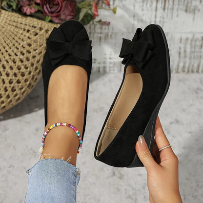 Women's black suede-effect ballet flats featuring a hidden wedge and stylish bow detail, perfect for comfortable and chic everyday wear. 0