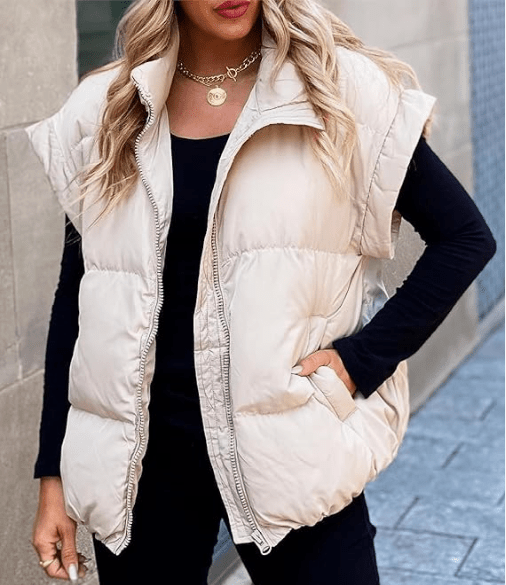 Women's black puffer vest featuring a high stand collar and zip front, designed for lightweight warmth and stylish layering. 0