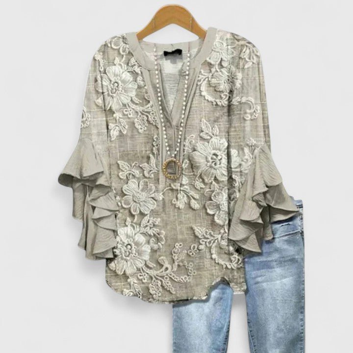 Women's blouse featuring an elegant floral print and stylish ruffled sleeves, designed for breathability and versatility in various settings. 1