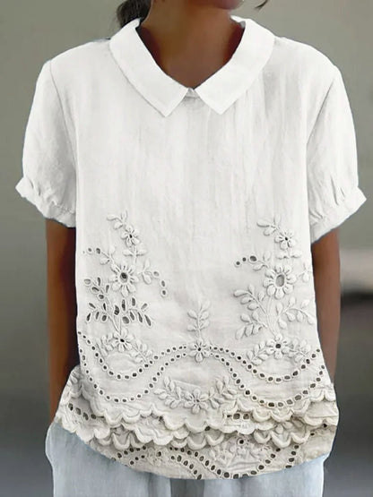 Womens blouse featuring delicate floral embroidery in a soft pink cotton linen blend with a relaxed fit. 1