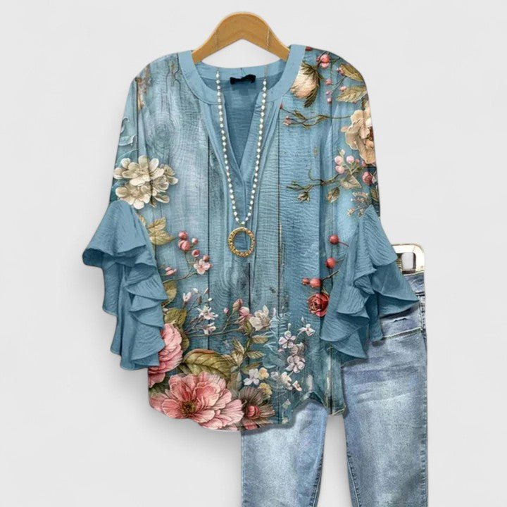 Womens blouse with ruffled sleeves and a vibrant floral print, designed as a lightweight summer top for women, perfect for casual outings and warm weather. 5