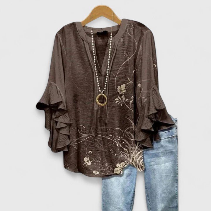 Womens blouse with ruffled sleeves and a vibrant floral print, designed as a lightweight summer top for women, perfect for casual outings and warm weather. 3