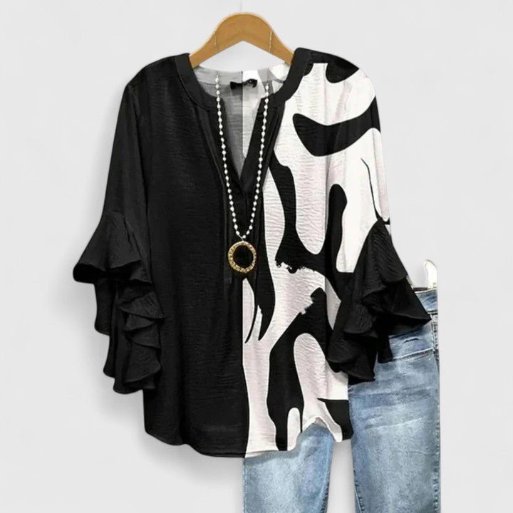 Womens blouse with ruffled sleeves and a vibrant floral print, designed as a lightweight summer top for women, perfect for casual outings and warm weather. 4