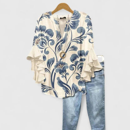 Womens blouse with ruffled sleeves and a vibrant floral print, designed as a lightweight summer top for women, perfect for casual outings and warm weather. 0