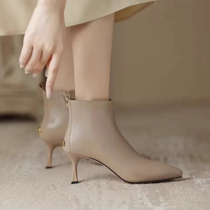 Elegant black women's boots featuring a slender kitten heel and pointed toe, designed for all-day comfort and style. 5