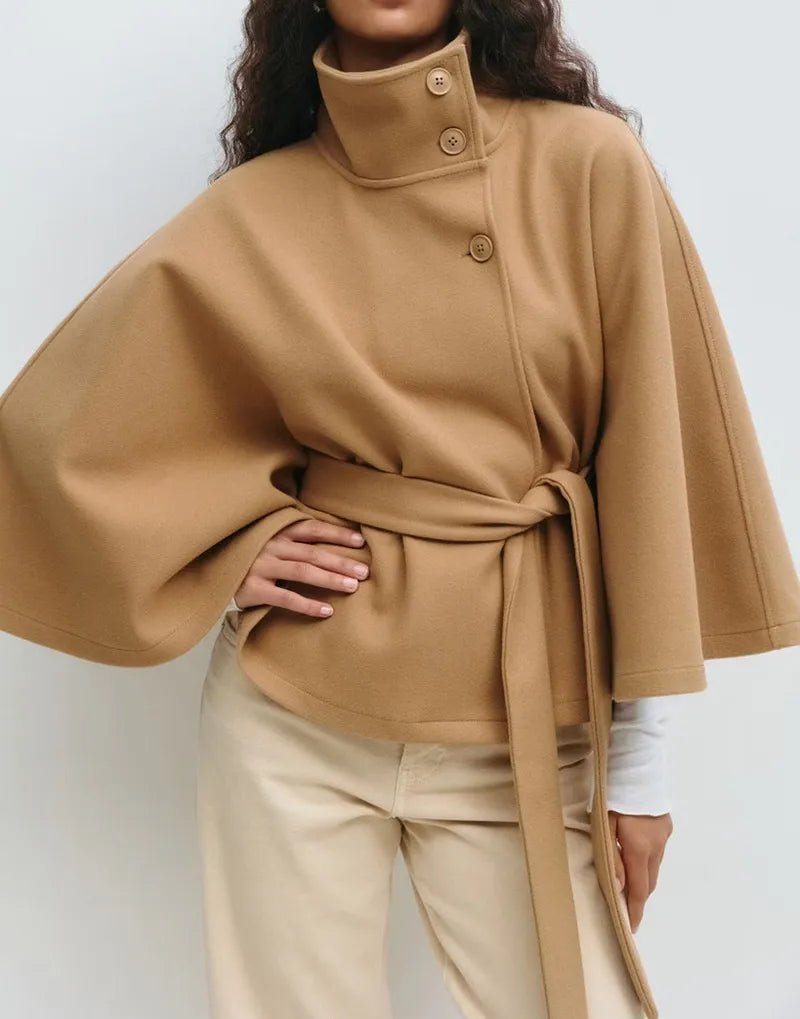 Women's cape coat featuring an adjustable waist belt and high neck, designed for elegant winter layering in a soft polyester blend fabric. 2