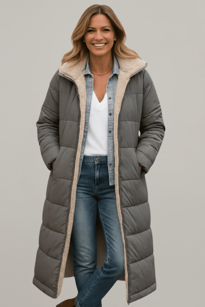 Women's quilted long winter coat with fixed hood and zip closure, designed for warmth and style during cold weather. 5