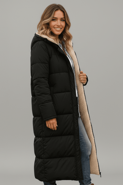 Women's quilted long winter coat with fixed hood and zip closure, designed for warmth and style during cold weather. 2