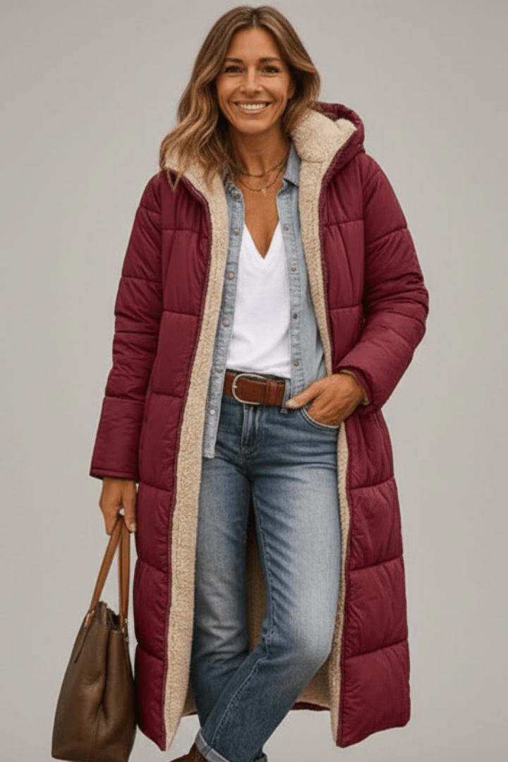 Women's quilted long winter coat with fixed hood and zip closure, designed for warmth and style during cold weather. 7