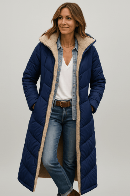 Women's quilted long winter coat with fixed hood and zip closure, designed for warmth and style during cold weather. 4