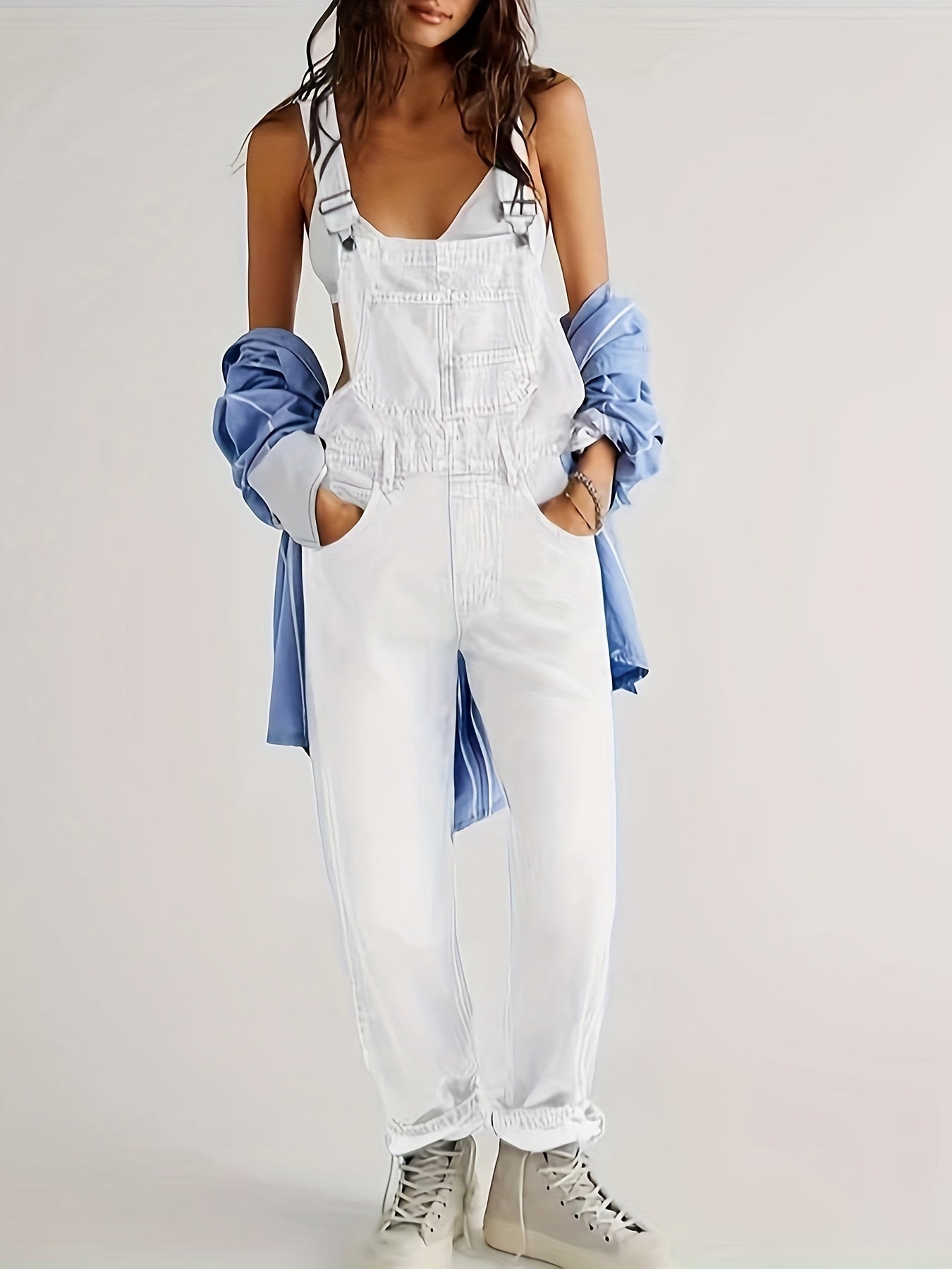 Women's denim jumpsuit featuring a casual relaxed fit, designed with functional pockets, perfect for all seasons. 0