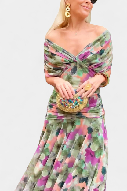 Floral print women's dress for weddings and events featuring a V-neckline, pleated waist, and a long flowing skirt. 5