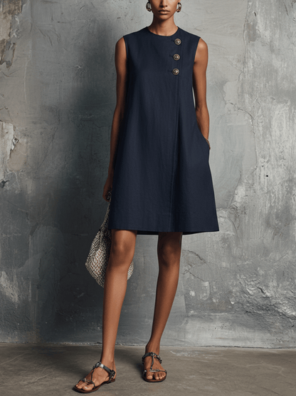Womens dress featuring an asymmetric button detail and side pocket, designed in a lightweight minimalist commuter style perfect for everyday wear. 0