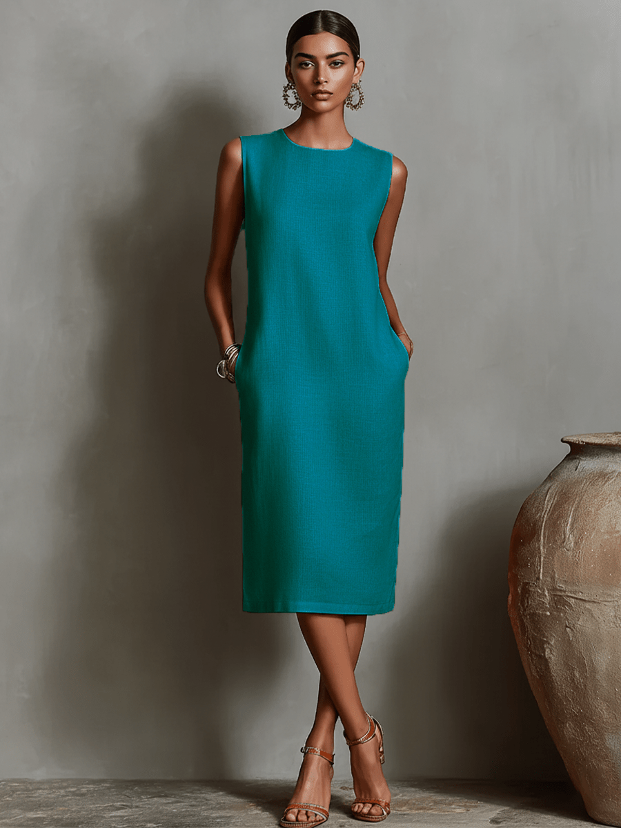 Womens sleeveless dress featuring a minimalist shift design, made from breathable linen fabric, with convenient side pockets for added functionality. 7