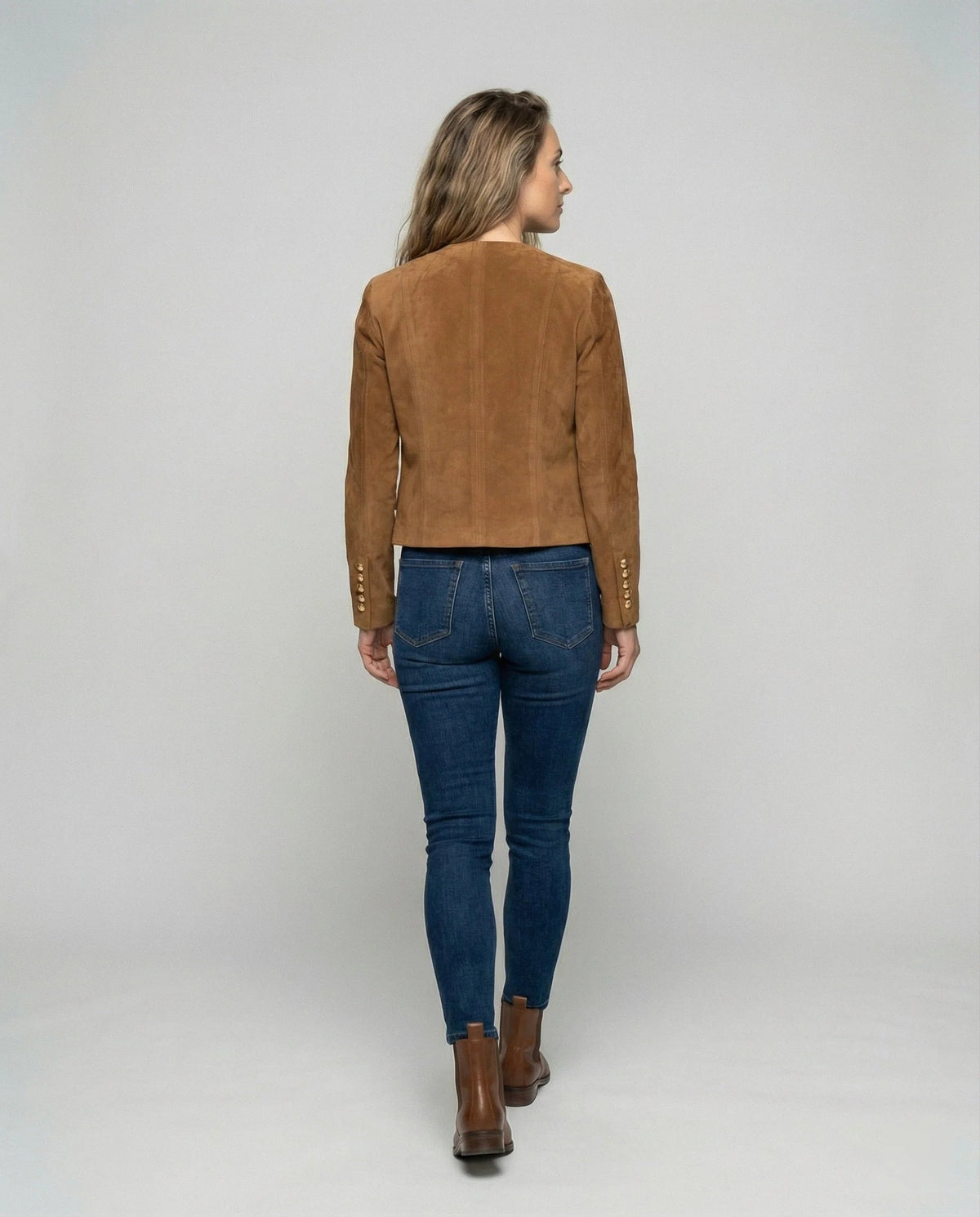 Women's faux suede jacket featuring a collarless cropped design and elegant gold buttons, perfect for a smart casual look. 2