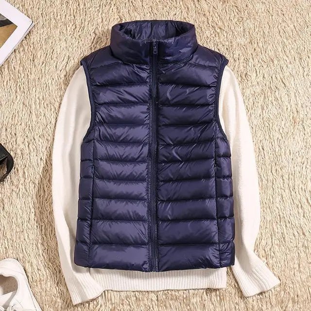Lightweight women's gilet featuring windproof protection and a fitted design, perfect for layering and outdoor activities. 11