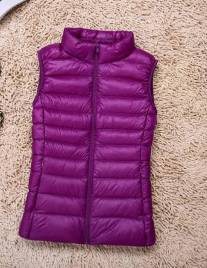 Lightweight women's gilet featuring windproof protection and a fitted design, perfect for layering and outdoor activities. 9