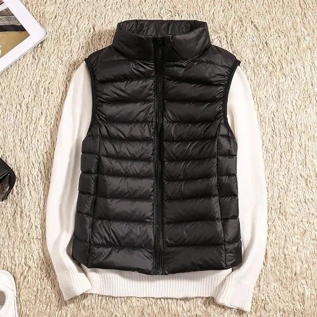 Lightweight women's gilet featuring windproof protection and a fitted design, perfect for layering and outdoor activities. 0