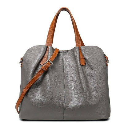 Women's genuine cowhide leather handbag with adjustable strap, featuring a spacious design ideal for everyday use. 2