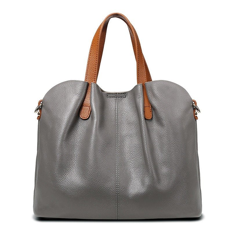 Women's genuine cowhide leather handbag with adjustable strap, featuring a spacious design ideal for everyday use. 0