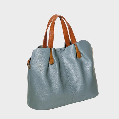 Women's genuine cowhide leather handbag with adjustable strap, featuring a spacious design ideal for everyday use. 7