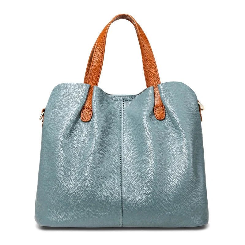 Women's genuine cowhide leather handbag with adjustable strap, featuring a spacious design ideal for everyday use. 1