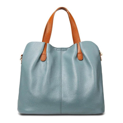 Women's genuine cowhide leather handbag with adjustable strap, featuring a spacious design ideal for everyday use. 1