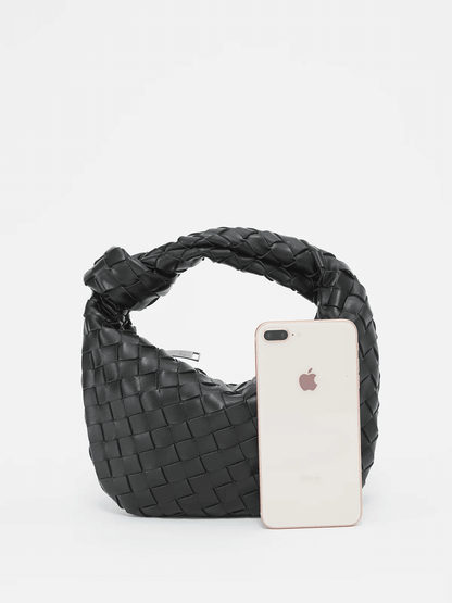 Women's vegan leather handbag featuring a stylish woven grid design, perfect for adding elegance and practicality to any outfit or occasion. 2