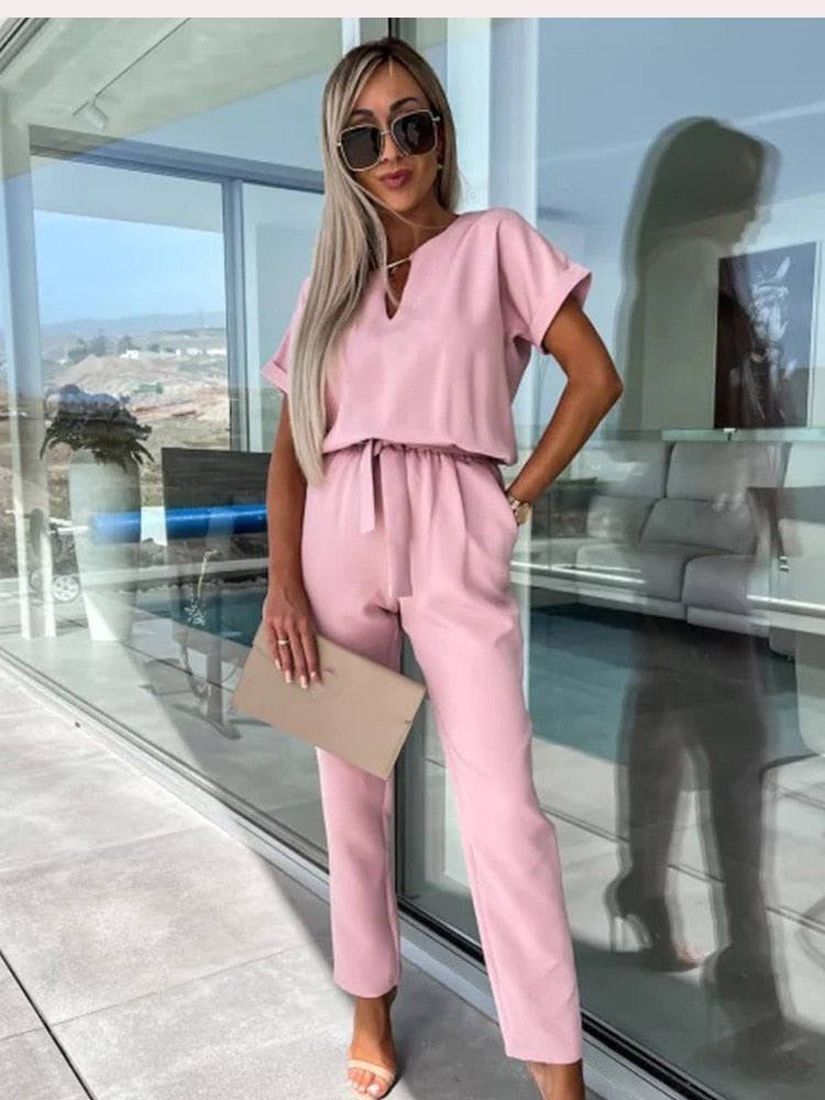 Women's elegant black jumpsuit featuring a flattering V-neckline and comfortable elastic waistband, perfect for transitioning from day to night. 3