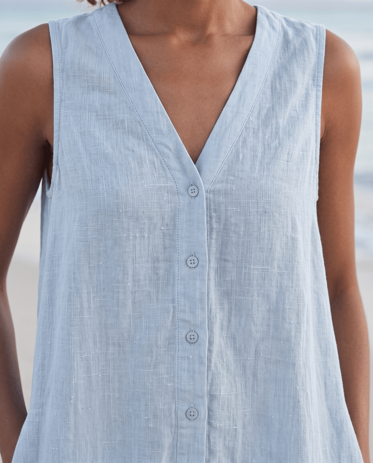 Women's linen midi dress featuring a stylish V-neck and a tiered skirt, perfect for casual beach wear in warm summer days. 2