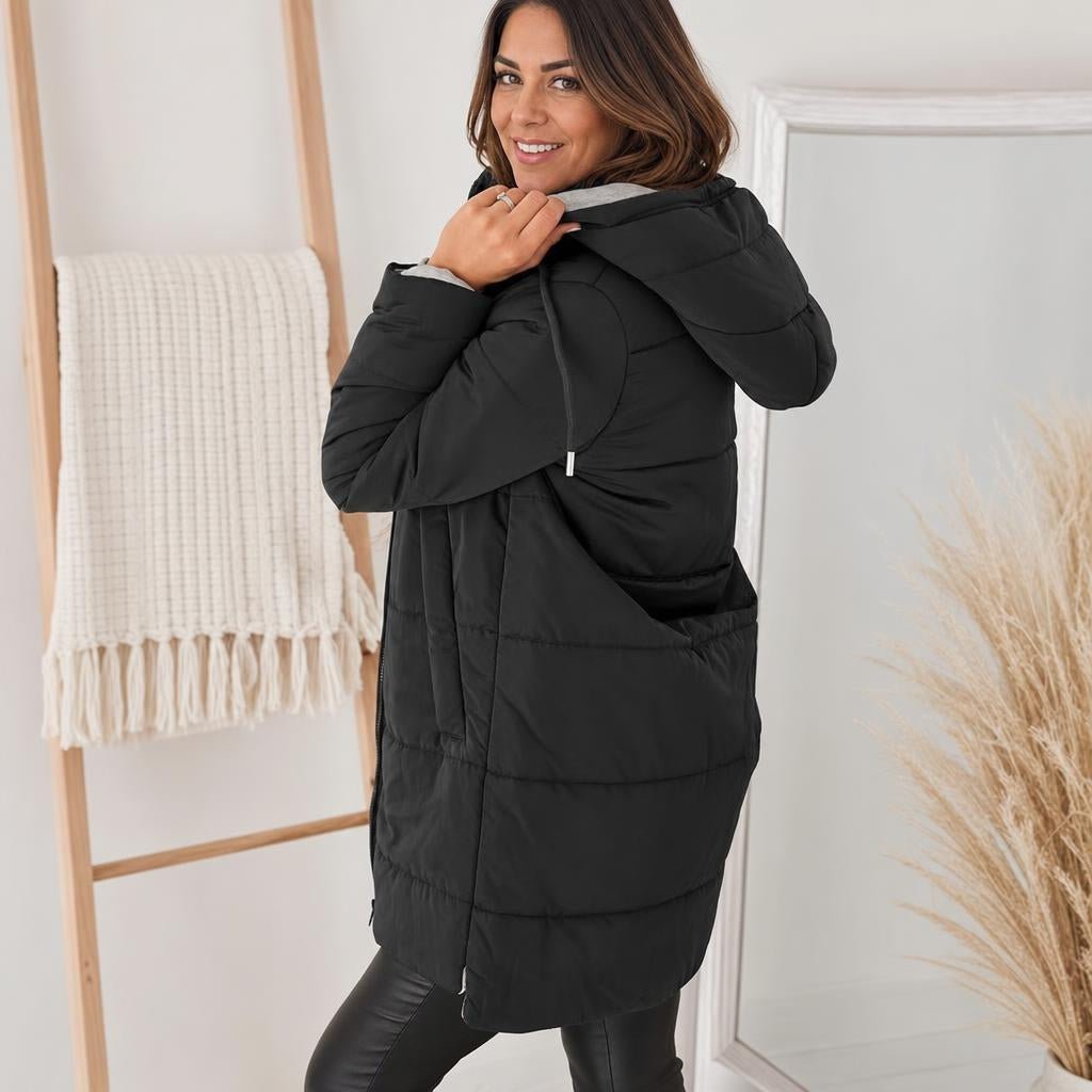 Women's longline quilted puffer jacket in black, featuring a zip front and practical pockets, ideal for cold weather wear. 3