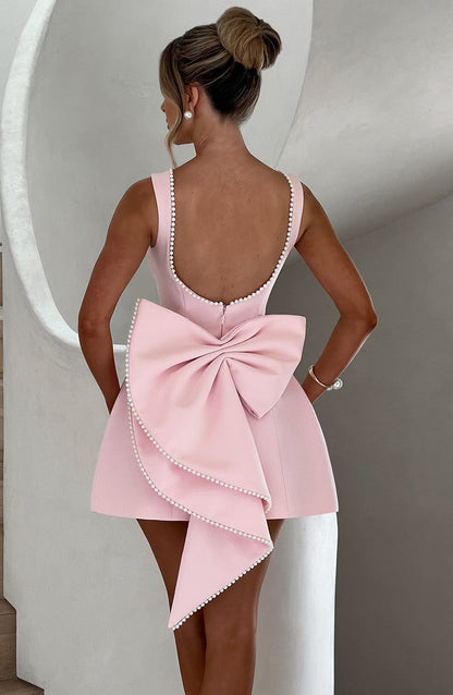 Women's mini dress featuring a stylish open bow back and elegant pearl trim, designed with a sleeveless relaxed fit, perfect for cocktail events and summer outings. 7