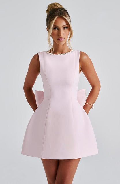 Women's mini dress featuring a stylish open bow back and elegant pearl trim, designed with a sleeveless relaxed fit, perfect for cocktail events and summer outings. 0