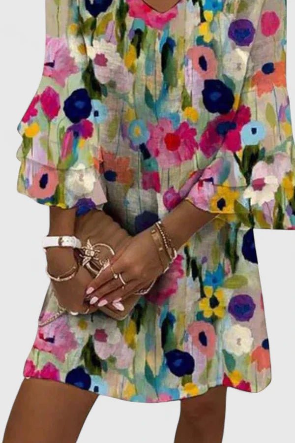 Women's mini dress featuring a flattering V-neckline and vibrant floral print, perfect for summer cocktail events and elegant occasions. 1