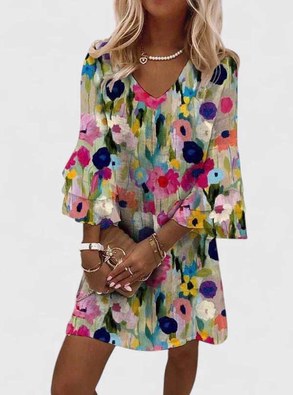 Women's mini dress featuring a flattering V-neckline and vibrant floral print, perfect for summer cocktail events and elegant occasions. 0