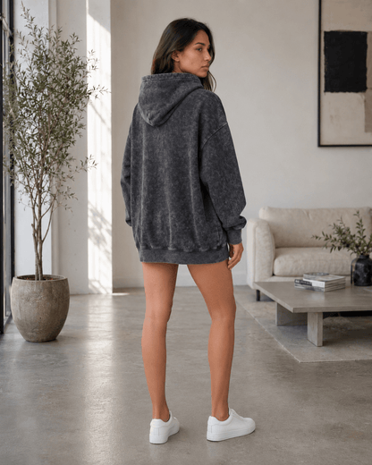 Women's oversized hoodie in washed black featuring a kangaroo pocket, perfect for casual wear and layering in any season. 1