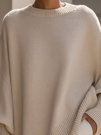 Women's oversized sweater in beige with an asymmetrical hem, made from a cozy wool blend, perfect for stylish layering and comfort in cooler weather. 1