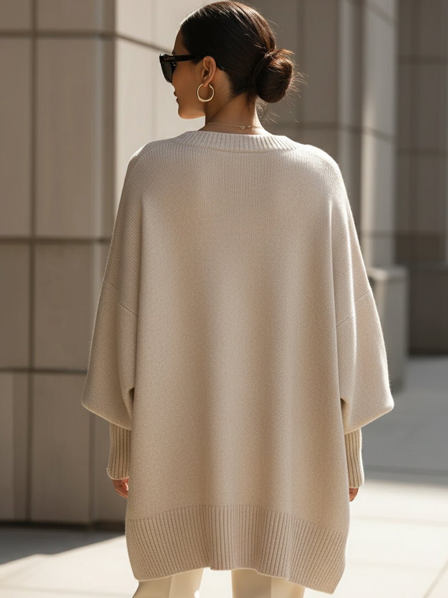 Women's oversized sweater in beige with an asymmetrical hem, made from a cozy wool blend, perfect for stylish layering and comfort in cooler weather. 3