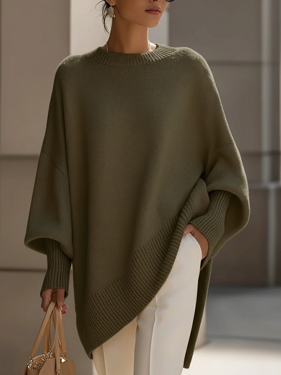Women's oversized sweater in beige with an asymmetrical hem, made from a cozy wool blend, perfect for stylish layering and comfort in cooler weather. 10