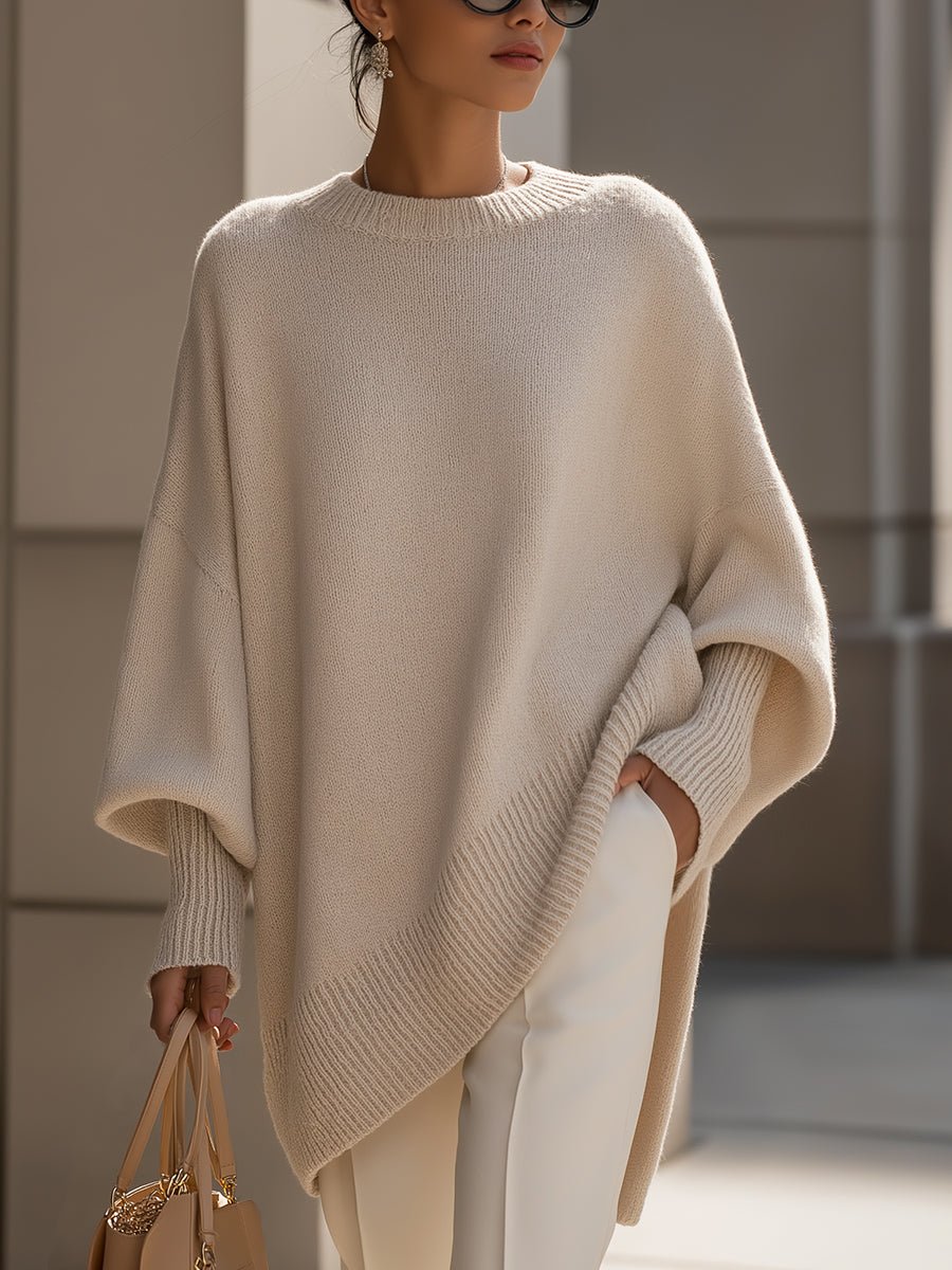 Women's oversized sweater in beige with an asymmetrical hem, made from a cozy wool blend, perfect for stylish layering and comfort in cooler weather. 0